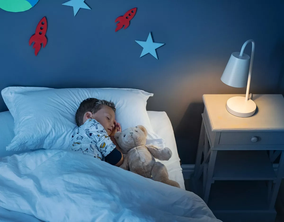 Sleeping boy in bed on the theme of the children's room