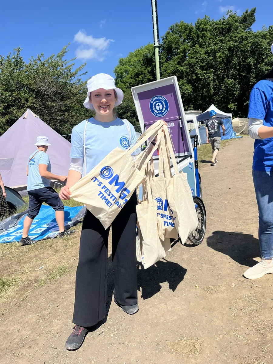 Young woman with Blue Angel bags in her hand