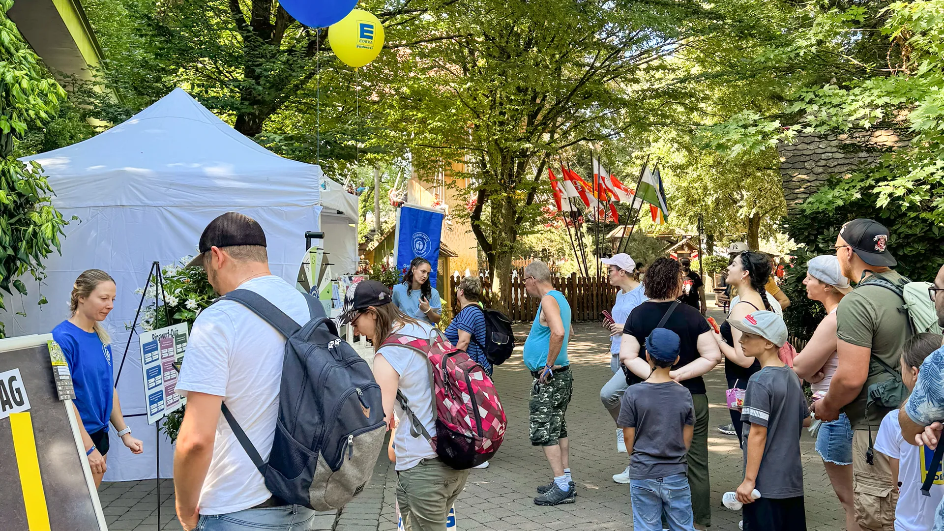 Blue Angel stand outdoors with a group of people queuing up for a quiz